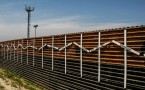 Mexico–United States barrier at the border of Tijuana, Mexico and San Diego, USA. The crosses represent migrants who died in the crossing attempt. Some identified, some not. Surveillance tower in the background.