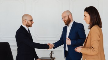 Men in Corporate Attire Shaking Hands at an Office